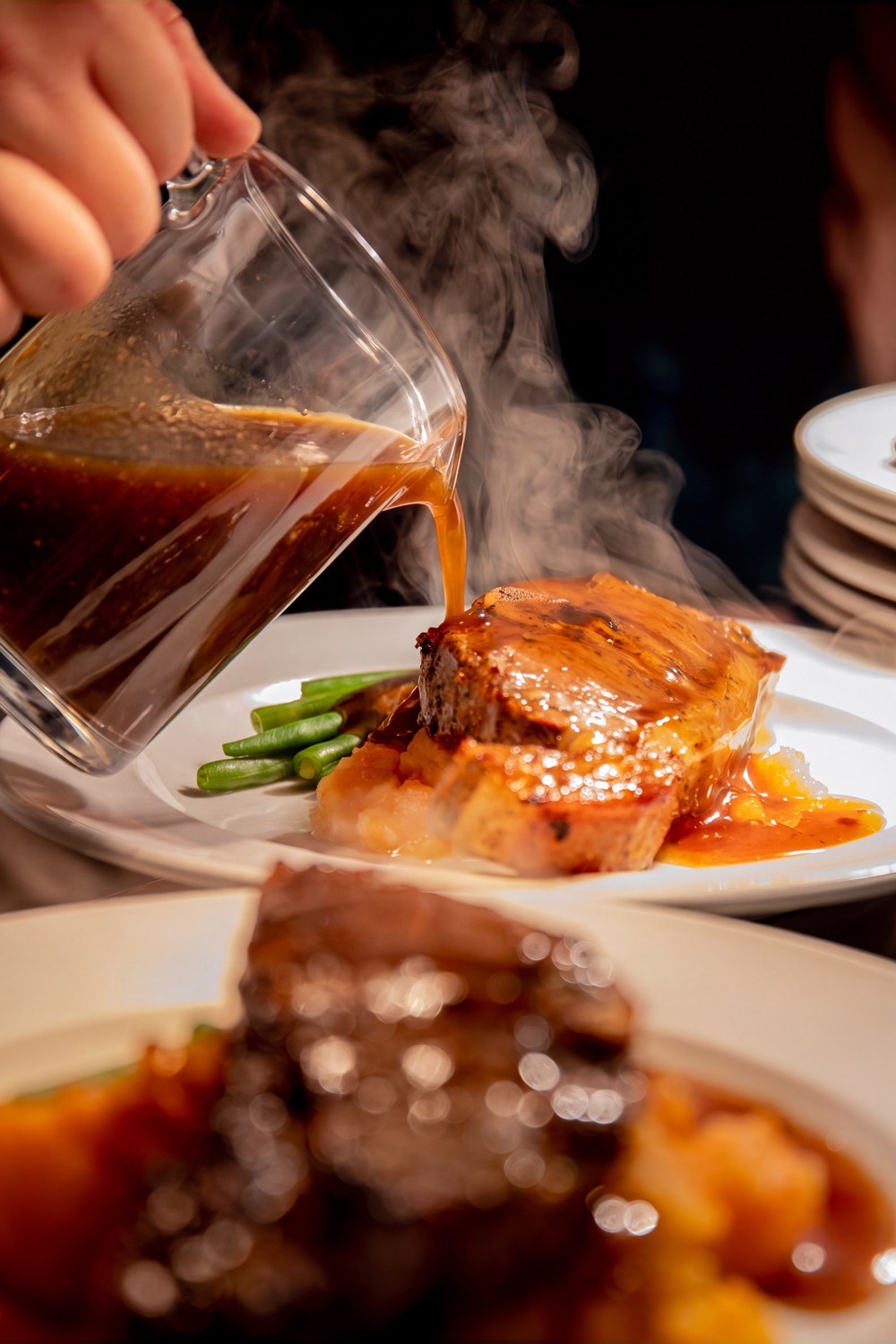 Steak with gravy being poured tableside